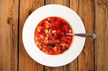 Portion of homemade Russian red beet soup borsch with bean, cabb
