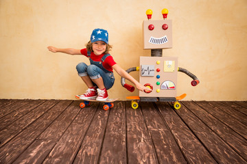 Happy kid playing with toy robot