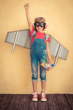 Happy Child With Toy Jetpack Playing At Home