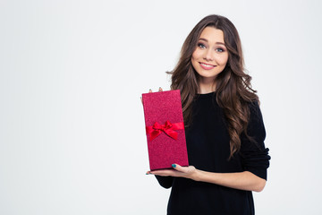 Smiling woman holding gift box and looking at camera