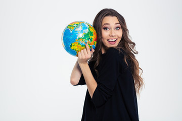 Cheerful woman holding globe and looking at camera