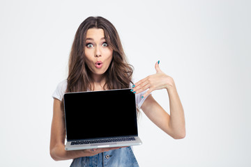 Woman pointing finger on blank laptop computer screen
