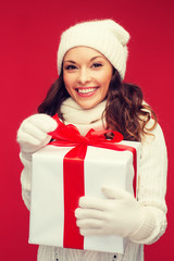 smiling woman in white clothes with gift box