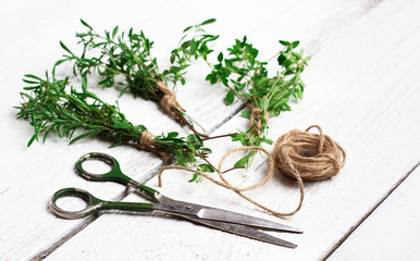 Mix of herbs on a wooden table, savory, thyme