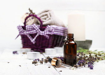 Dry lavender and oil  on a white wooden table