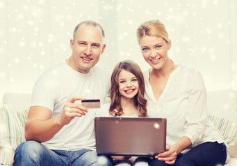 happy family with laptop computer and credit card