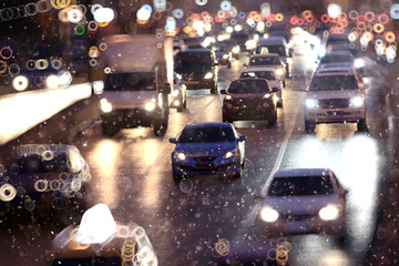 Snow in the city night traffic road transport