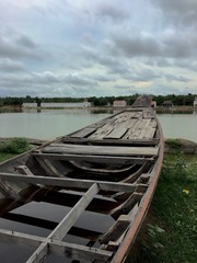 vintage broken boat, thai style, at river side