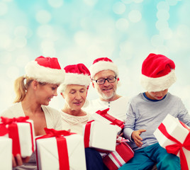 happy family in santa helper hats with gift boxes