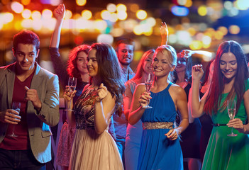 happy friends with champagne dancing at nightclub - obrazy, fototapety, plakaty