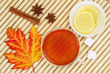 Autumn leaf, cup of tea, lemon, star anise and cinnamon

