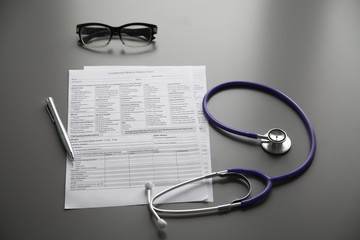 Stethoscope on the grey desk, close up