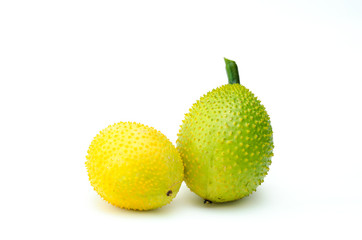 Gac fruit green and yellow on a white background