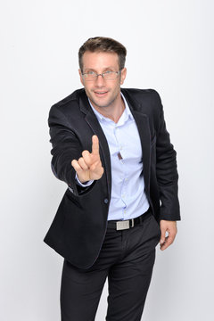 Business man with pointing to something or touching a touch screen on white background..