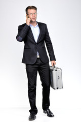  young business man talking at the phone  on white background..