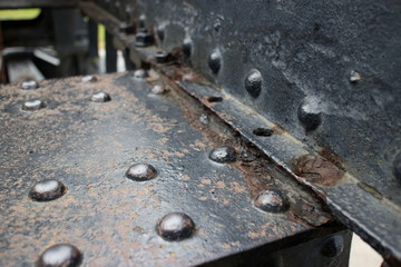 Angled view of old vintage canon fixture with rivets and holes