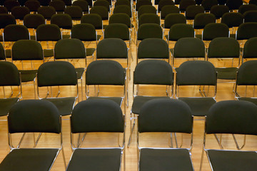 Rows of empty chairs in a seminar hall