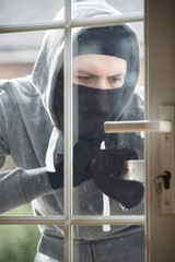 Burglar Breaking Into House By Forcing Door With Crowbar