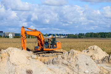 Obraz premium track-type loader excavator machine doing earthmoving work at sa