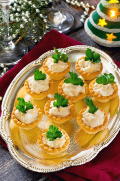 Tartlets with cod liver mousse on New Year's Eve, selective focu