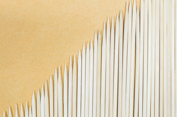 Wood stick for meatball skewers on brown paper texture background