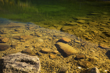 Clear, transparent emerald and orange water, White Mountains, Ne