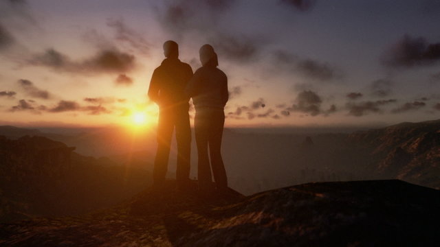 Couple on top of the mountain, timelapse clouds at sunset