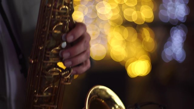 guy playing the saxophone at the party