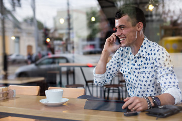 Businessman in a cafe talking on the phone