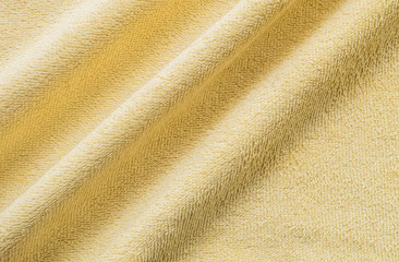 Fototapeta na wymiar Closeup wrinkled yellow napkin fabric background