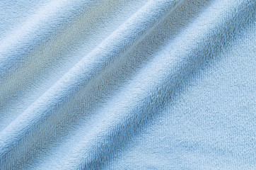 Fototapeta na wymiar Closeup wrinkled blue napkin fabric background