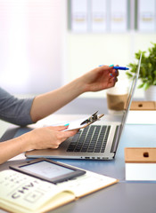 Fototapeta premium young girl the designer of the table with a laptop