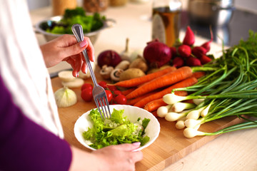 Young woman cutting vegetables in the kitchen