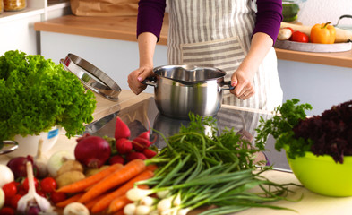 A young girl in kitchen while cooking