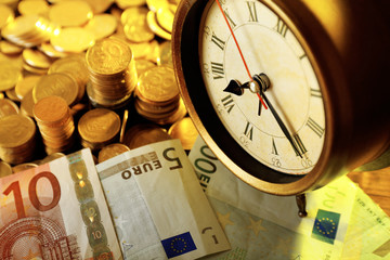 Money and alarm clock, closeup