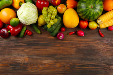 Heap of fruits and vegetables on wooden background