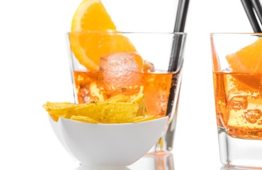 hot tacos chips in front of two glasses of spritz aperitif aperol cocktail with orange slices and...