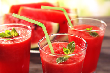Glasses of watermelon juice on wooden table, closeup