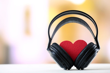 black headphones with heart on unfocused background