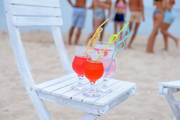 Refreshing cocktail on chair outdoors