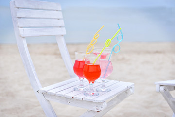 Refreshing cocktail on chair outdoors