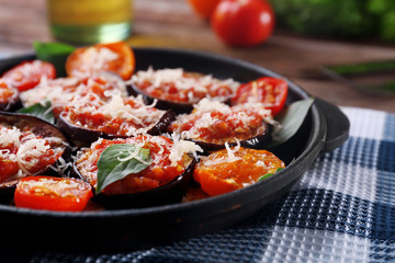 Baked vegetables in pan on table, close-up