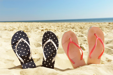 Flip flops on beach sand closeup