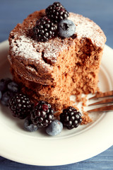 Cake with berries on wooden table