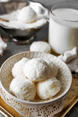 Homemade Candies in coconut flakes and fresh coconut on light background