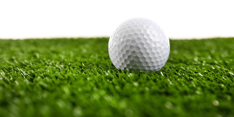 Golf ball on grass isolated on white
