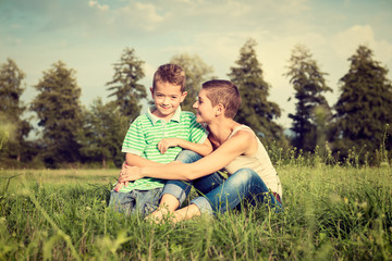 Fototapeta premium Mother and son posing for an outdoor portrait, smiling