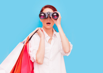 woman with shopping bags and binocular