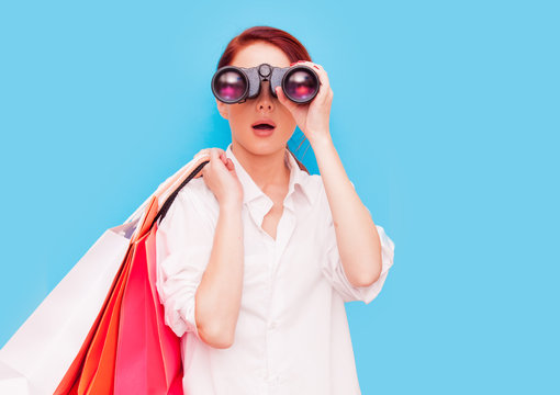 woman with shopping bags and binocular
