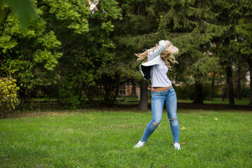 young attractive girl in a hat sunny summer day in the park